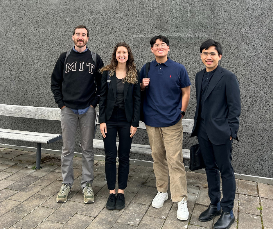 Picture of the 4 MIT students in front of a gray wall
