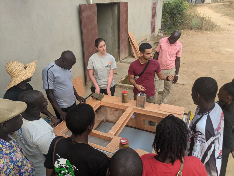 Katana Finlason and Aly Kombargi showing thermal batteries and Off-Grid Brooder to poultry farmers