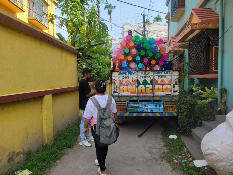 Many colorful dispensers piled in a truck in India.