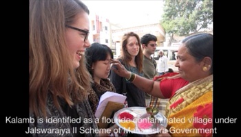 Researchers having powder put on forehead by local woman
