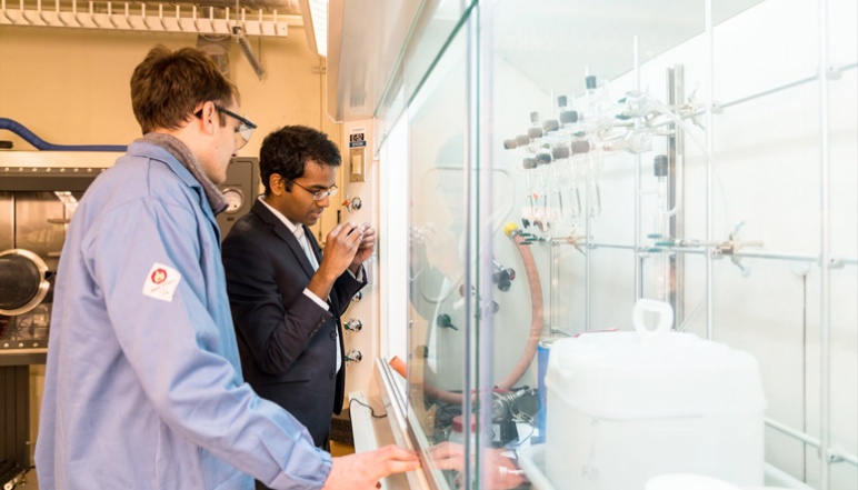 Manthiram and researcher by fume hood