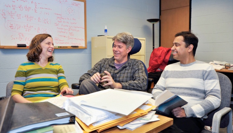 Harvey and fellow researchers indoors talking