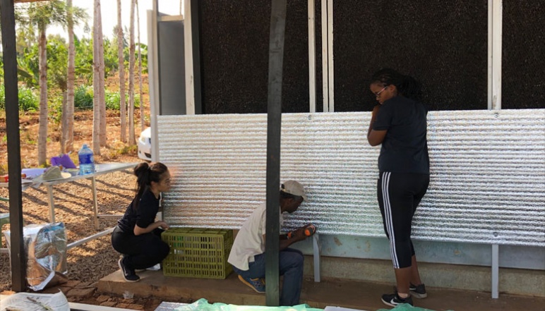 Umubyeyi, Luu, and El-Yahkim building charcoal ECC with reflective panels