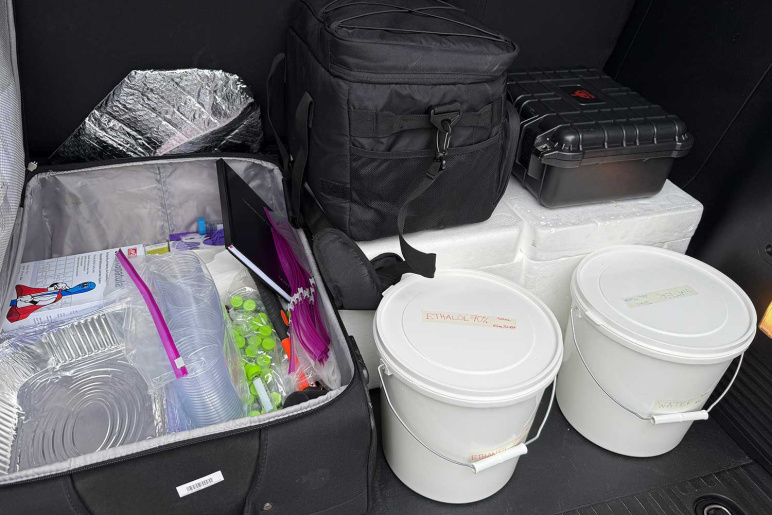 sampling cups and tubes, aluminum trays, ethanol and water buckets, all in the back of a van as part of the mobile lab
