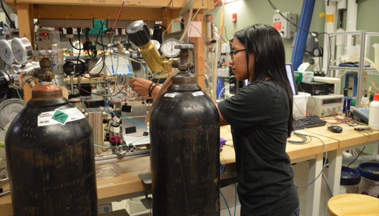 Researcher adjusts wires for experiment