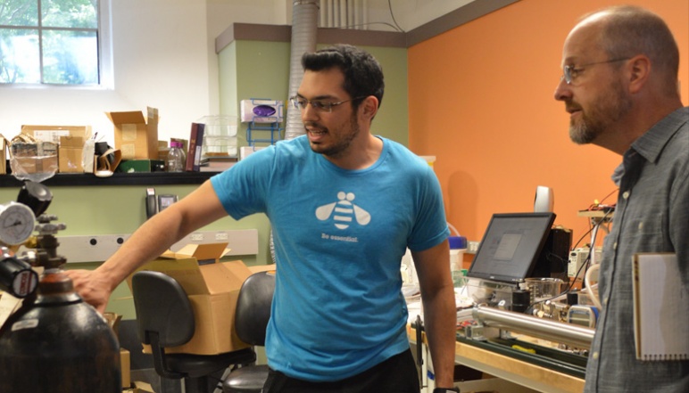 Researcher talking about project in lab