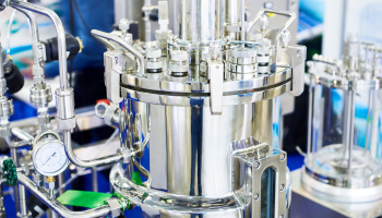 A silver, metal machine on a lab bench. 