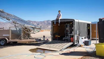A man sitting on top of a large trailer