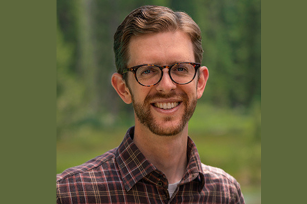 Headshot of Scott Odell with a green background
