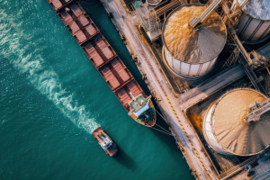 A large boat next to a large food mill