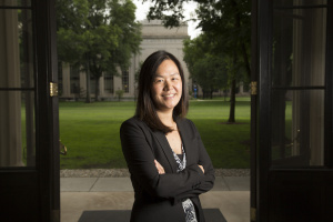 Evelyn Wang standing in front of a blurry green background