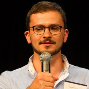 Man with beard and mustache holding microphone