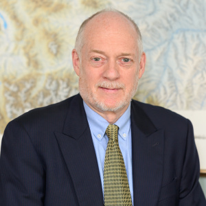 Tim Swager in a suit coat and tie against a floral wallpaper background