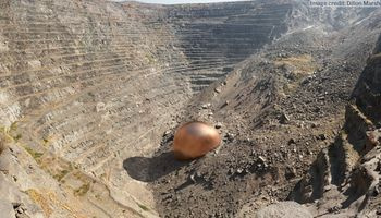 An aerial shot of a mine with a visual representation of the amount of copper extracted compared to the footprint of the extraction 