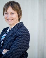 MIT's Vice president of research, Maria Zuber, standing with arms folded smiling