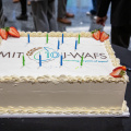 The J-WAFS anniversary cake with the J-WAFS logo and blue and green candles 